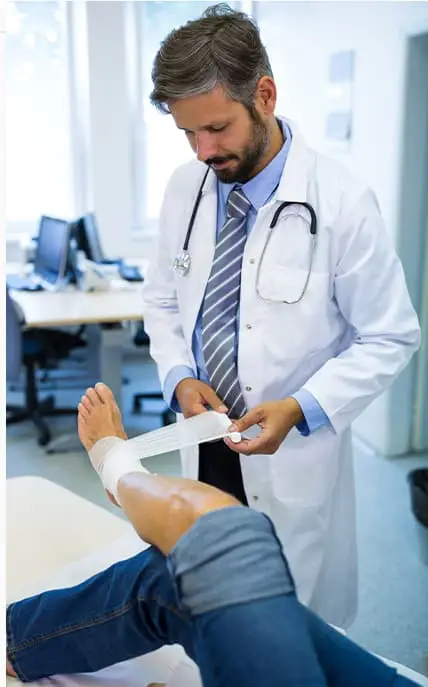 doctor wrapping a patient's foot