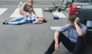 Woman-helping-an-unconscious-victim from a bicycle accident