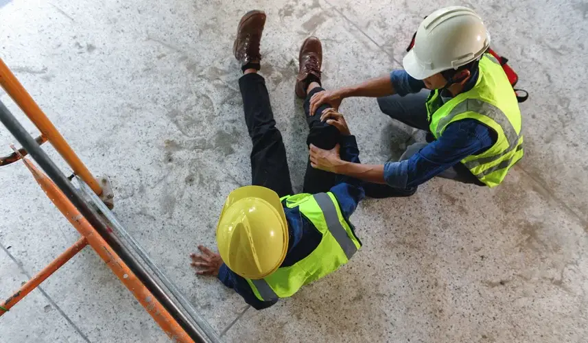 a man helping out an injured coworker from Construction Accidents/