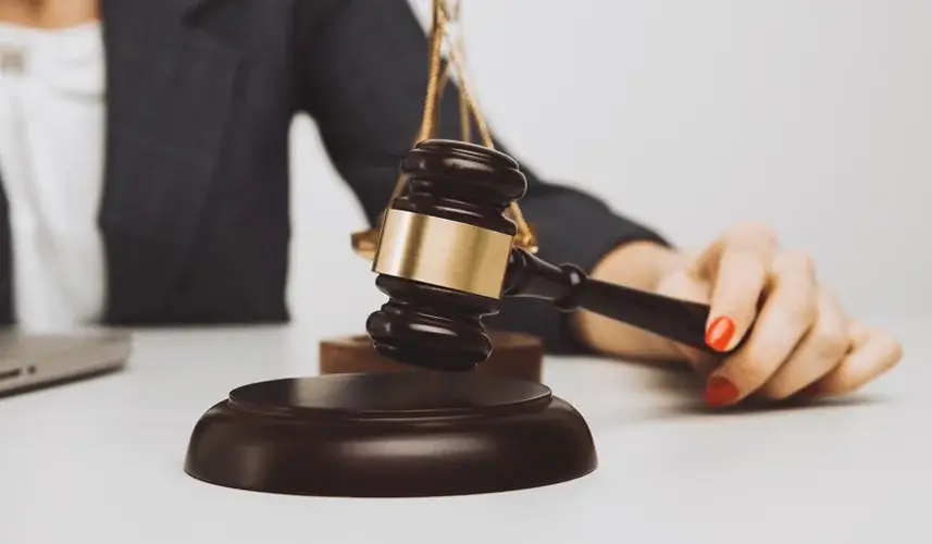 a woman attorney holding a gavel